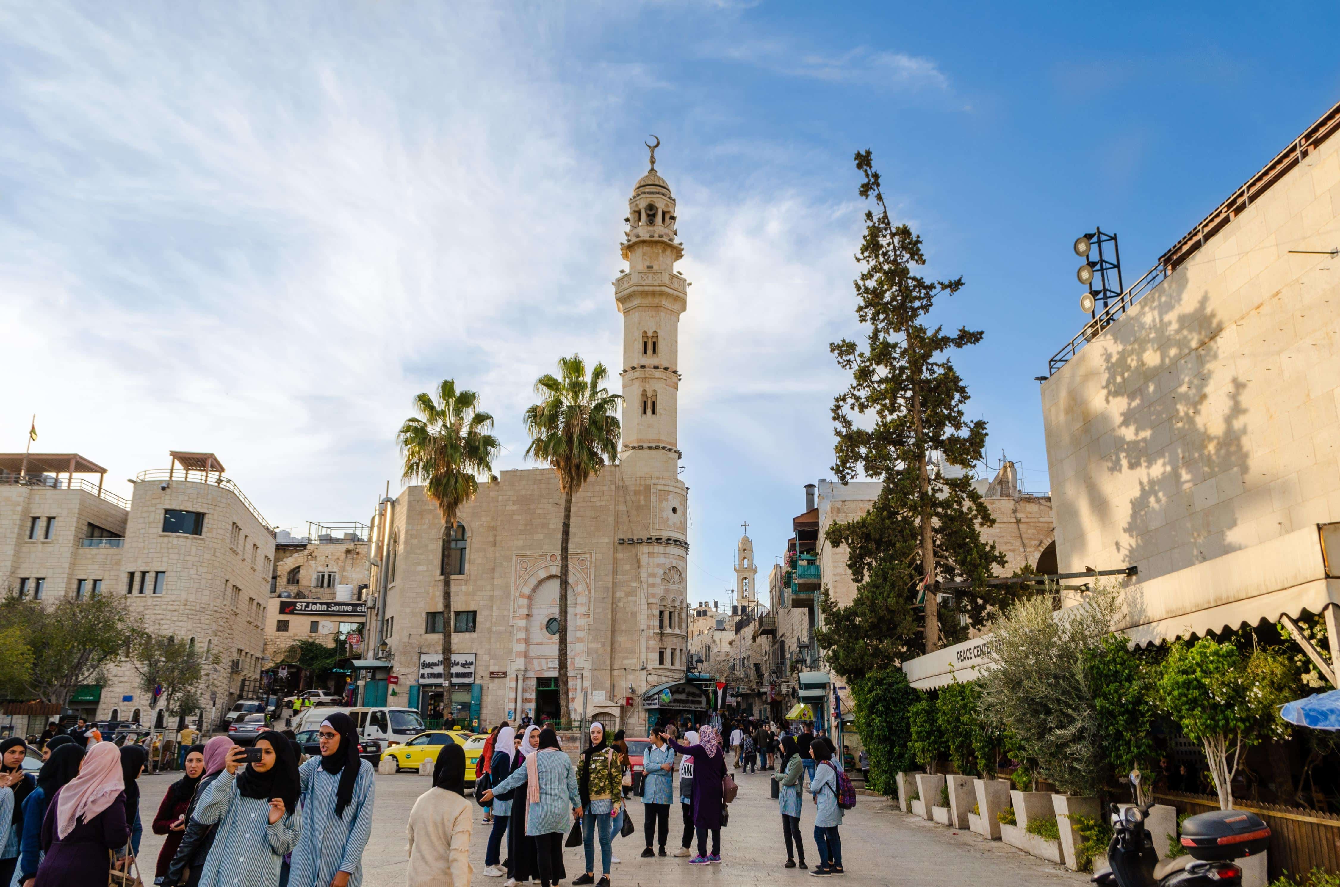 Bethlehem, Palestine - December 19 2019: View of the Mosque of Omar (Umar). The Omar Mosque is the oldest in the city of Bethlehem. People walking through the city center and sightseeing.