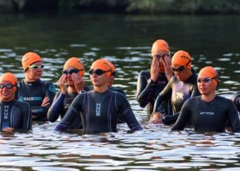 ST NEOTS, CAMBRIDGESHIRE, ENGLAND - SEPTEMBER 10, 2023: Womens Triathlon Competitors waiting at the start of swimming leg.