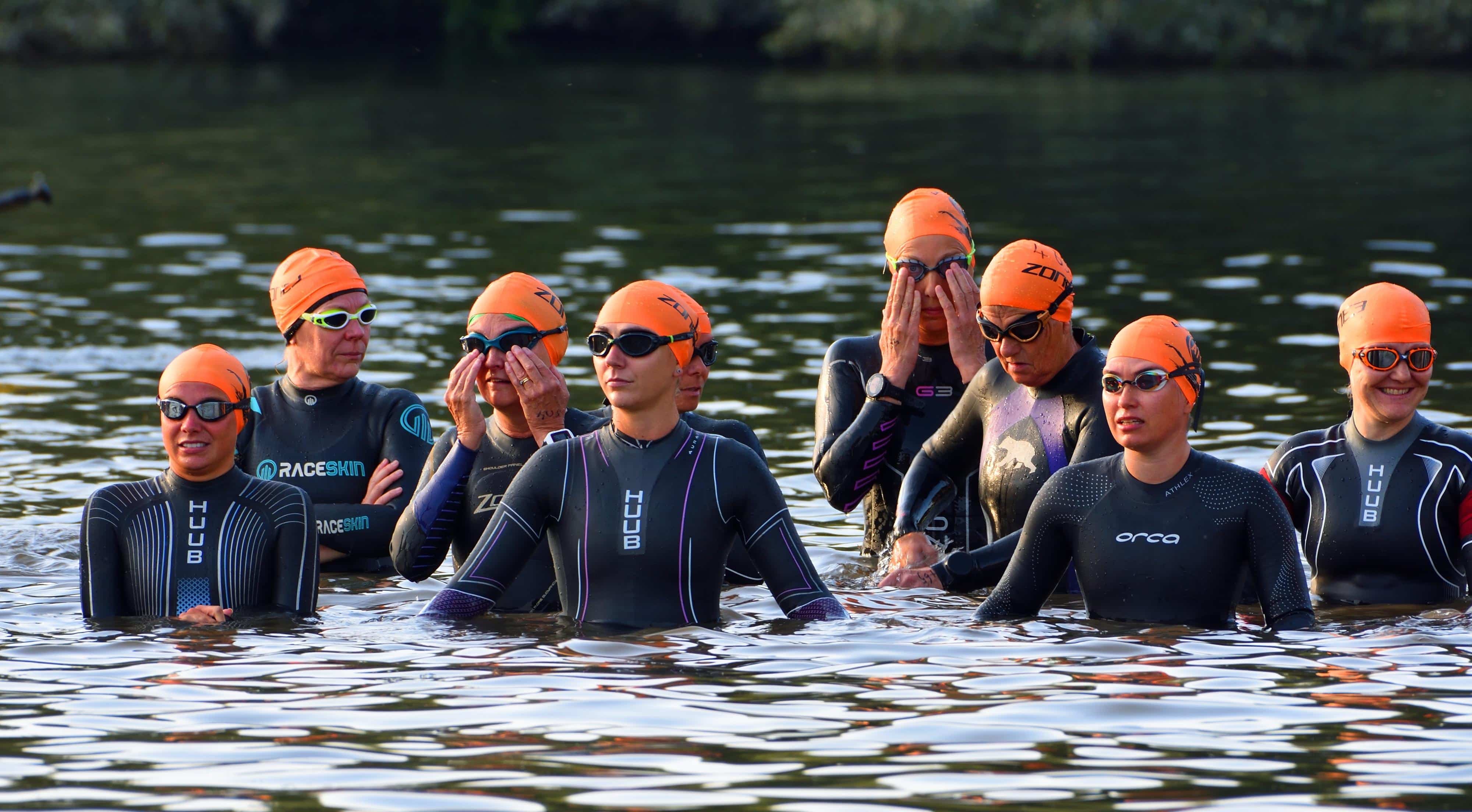 ST NEOTS, CAMBRIDGESHIRE, ENGLAND - SEPTEMBER 10, 2023: Womens Triathlon Competitors waiting at the start of swimming leg.