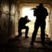 Silhouette of special forces operators with weapons in the tunnel