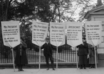 Protest for amnesty for victims of Espionage Act of 1917 and Sedition Act of 1918. In 1922 a sign reads, 'America First? Is the last country in the world to release its wartime political prisoners'. H