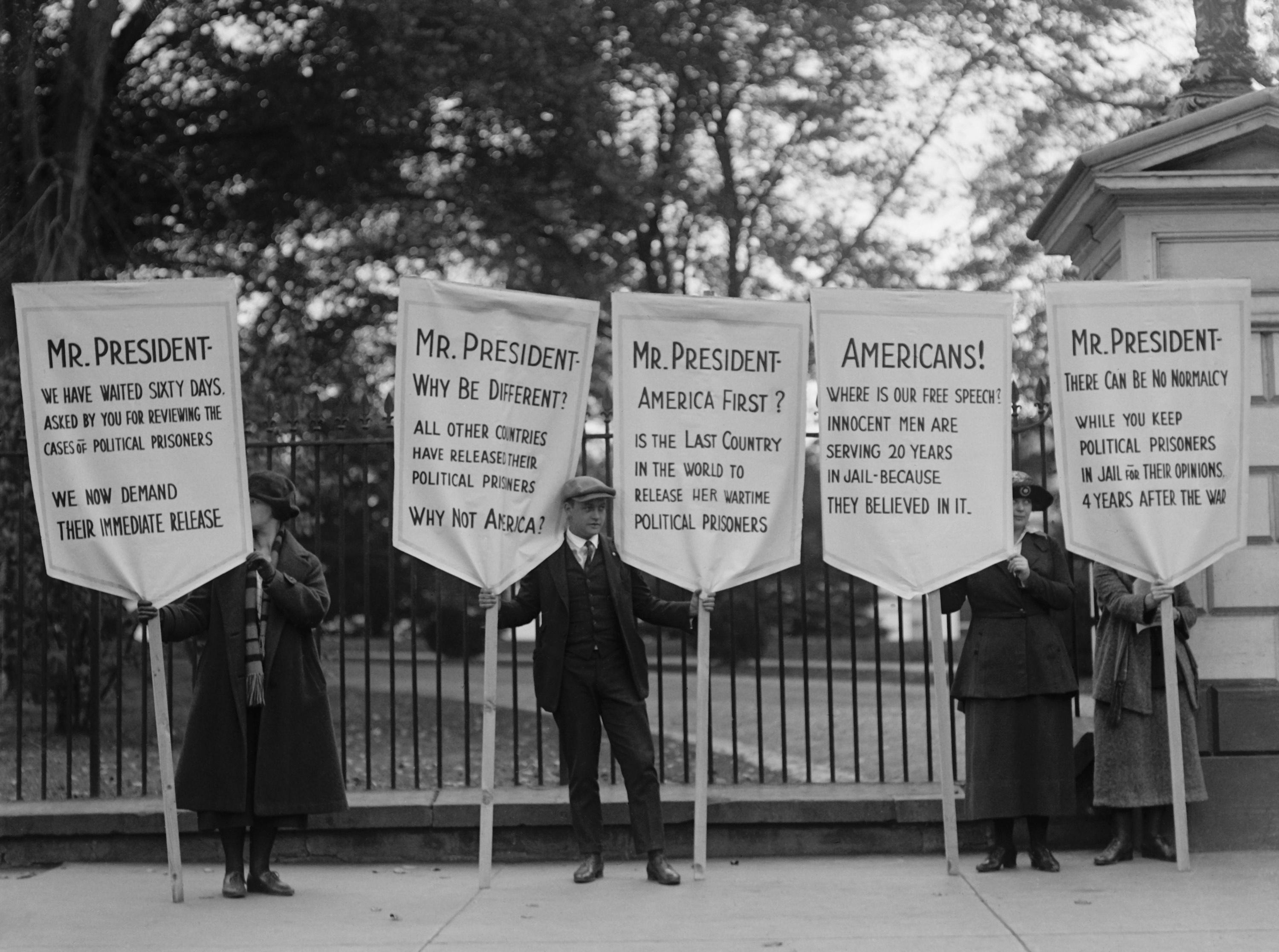 Protest for amnesty for victims of Espionage Act of 1917 and Sedition Act of 1918. In 1922 a sign reads, 'America First? Is the last country in the world to release its wartime political prisoners'. H