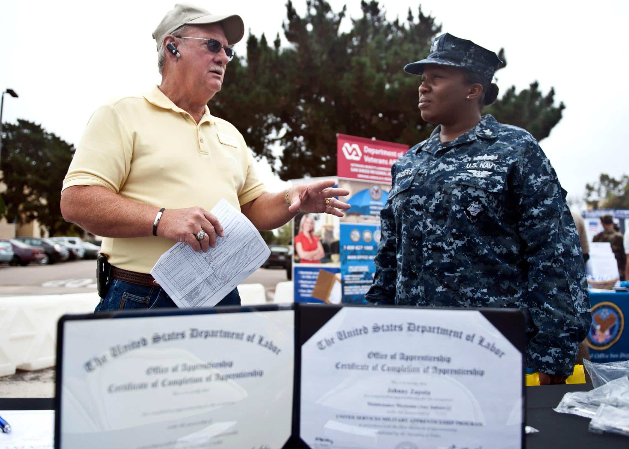 Kenneth Ledbetter, marketing outreach coordinator of the United States Military Apprenticeship Program, discusses certification programs with a sailor during the annual education fair at Naval Air Station North Island. The educational fair hosted more than 75 colleges and universities and provided sailors an opportunity to learn about various degree programs offered by each school and certifications that can be earned through USMAP and Navy COOL.