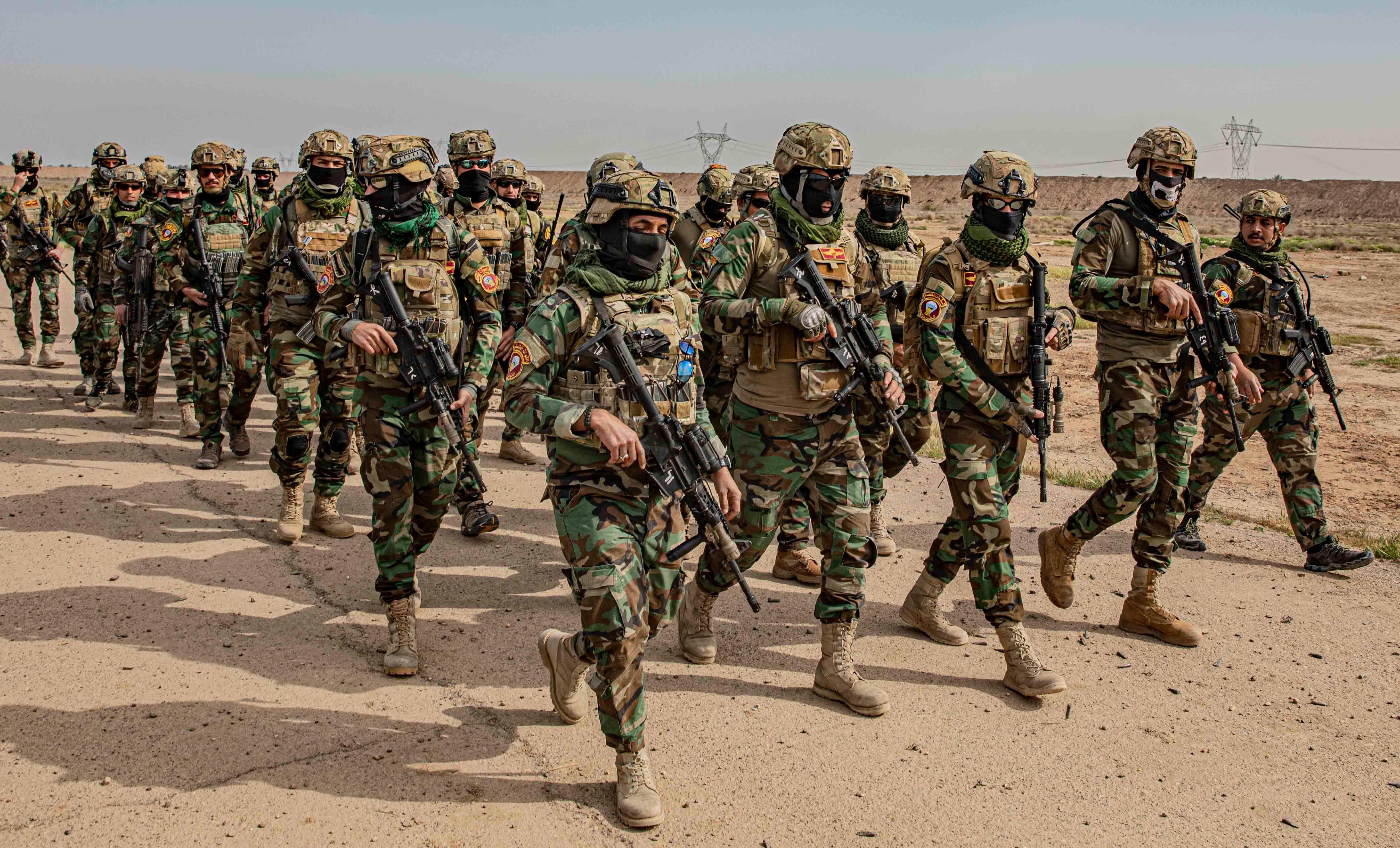 Soliders with Qwat al Khasah, the Special Forces of Iraq, march in formation as they take part in training for an upcoming mission at Camp Taji, Iraq March 7, 2020. The Qwat al Khasah, Special Forces of Iraq, are leading a coalition of nations in the fight against Daesh by interrupting enemy operations to continue the further stabilization of Iraq. (U.S. Army photo by Sgt. Robert Douglas).