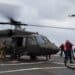 A U.S. Navy crew of boatswain mates work together to refuel a U.S. Army UH-60 Blackhawk helicopter during deck landing qualifications aboard USS John Paul Jones, off the coast of Oahu, Hawaii, November 15, 2021. Deck landing qualifications are conducted annually to maintain proficiency, allowing continued joint operations and training throughout the Indo-Pacific. (U.S. Army photo by Spc. Matthew Mackintosh, 28th Public Affairs Detachment)
