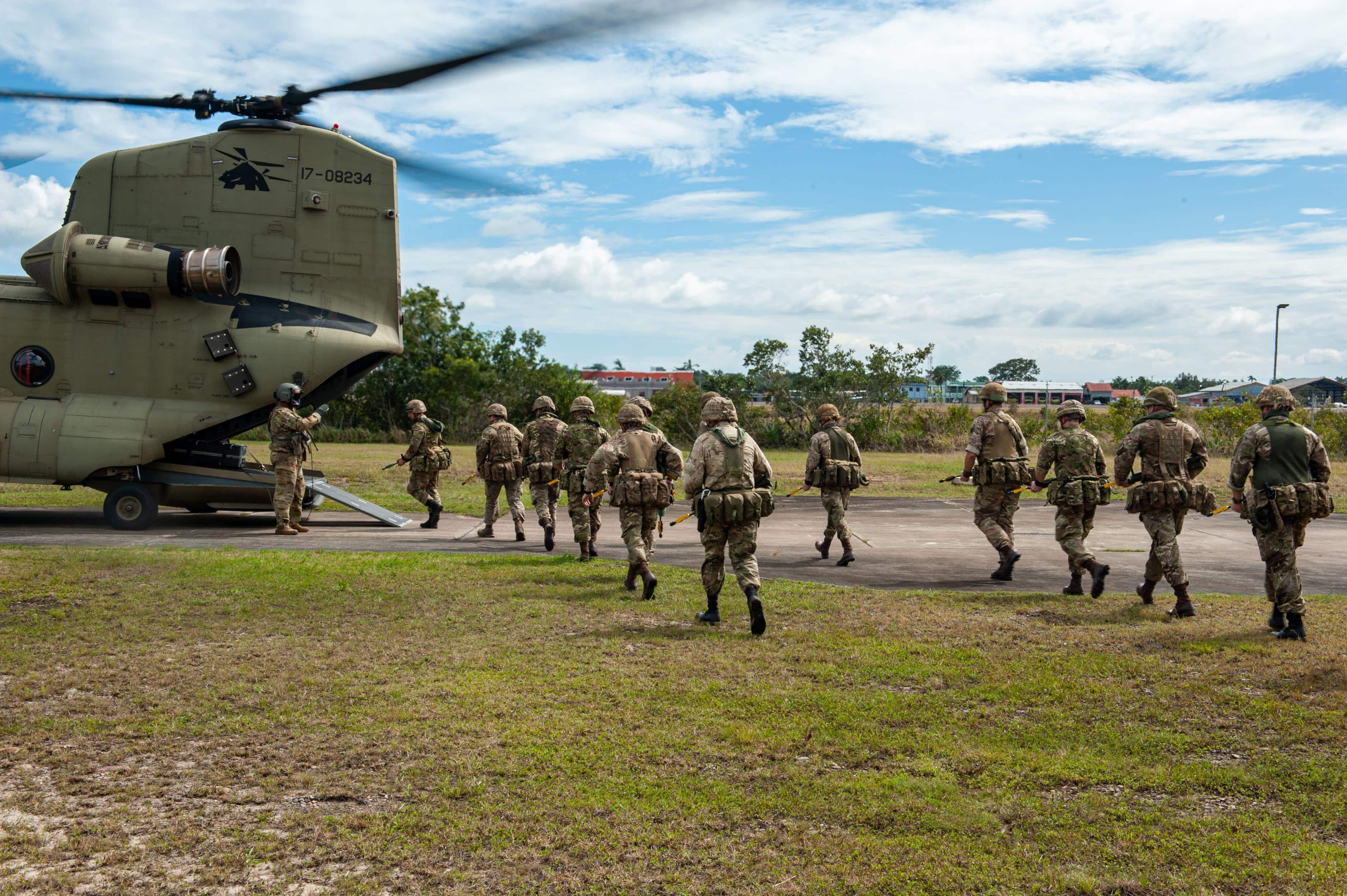 Service members from the British Army's 3rd Battalion Parachute Regiment (3 PARA), board a CH-47 Chinook assigned to Joint Task Force Bravo’s 1st Battalion, 228th Aviation Regiment before taking off from British Army Training Support Unit Belize, Belize, Feb. 8, during a joint air assault training exercise. JTF-Bravo routinely trains with mission partners to better prepare for joint operations within Central America and provide support when requested from host nations. (U.S. Air Force photo by Capt. Allen Palmer)