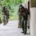 U.S. and Ecuadorian Special Forces breach and clear a shoot house during close quarter combat training for a culminating exercise in Ecuador on May 21, 2022. The overall exercise promotes military-to-military relationships, increases mission readiness, and improves regional security.