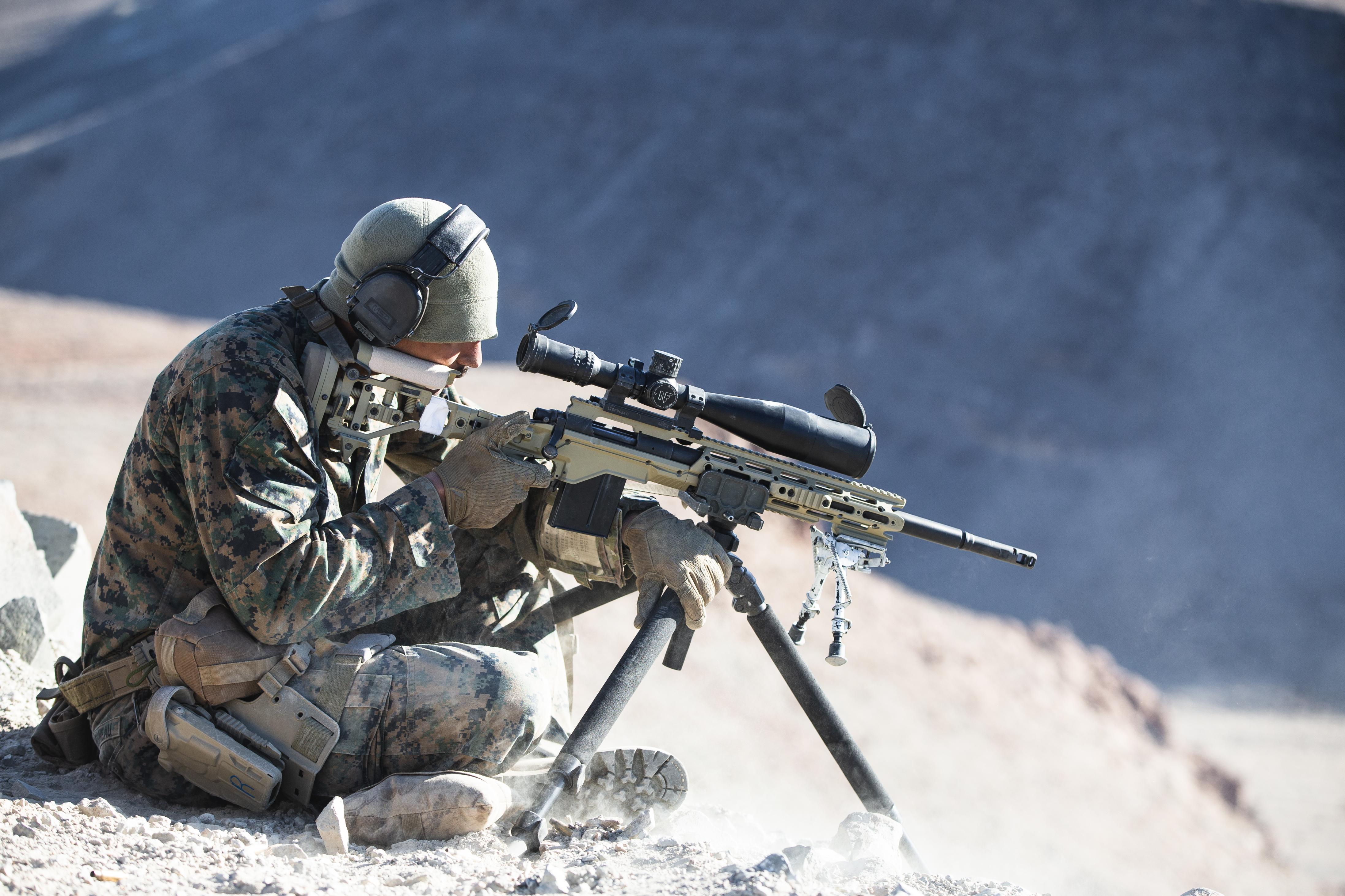 U.S. Marine Corps Cpl. Tyler Duchesneau, a Scout Sniper with Weapons Company, 1st Battalion, 4th Marine Regiment, engages downhill targets with a M40A6 Sniper Rifle during Mountain Scout Sniper Course at Hawthorne Army Depot, Hawthorne, Nevada, Feb. 1, 2022. Marines trained to shoot at high angles in complex weather conditions, preparing them for operations in mountainous environments. (U.S. Marine Corps photo by Lance Cpl. Andrew R. Bray)