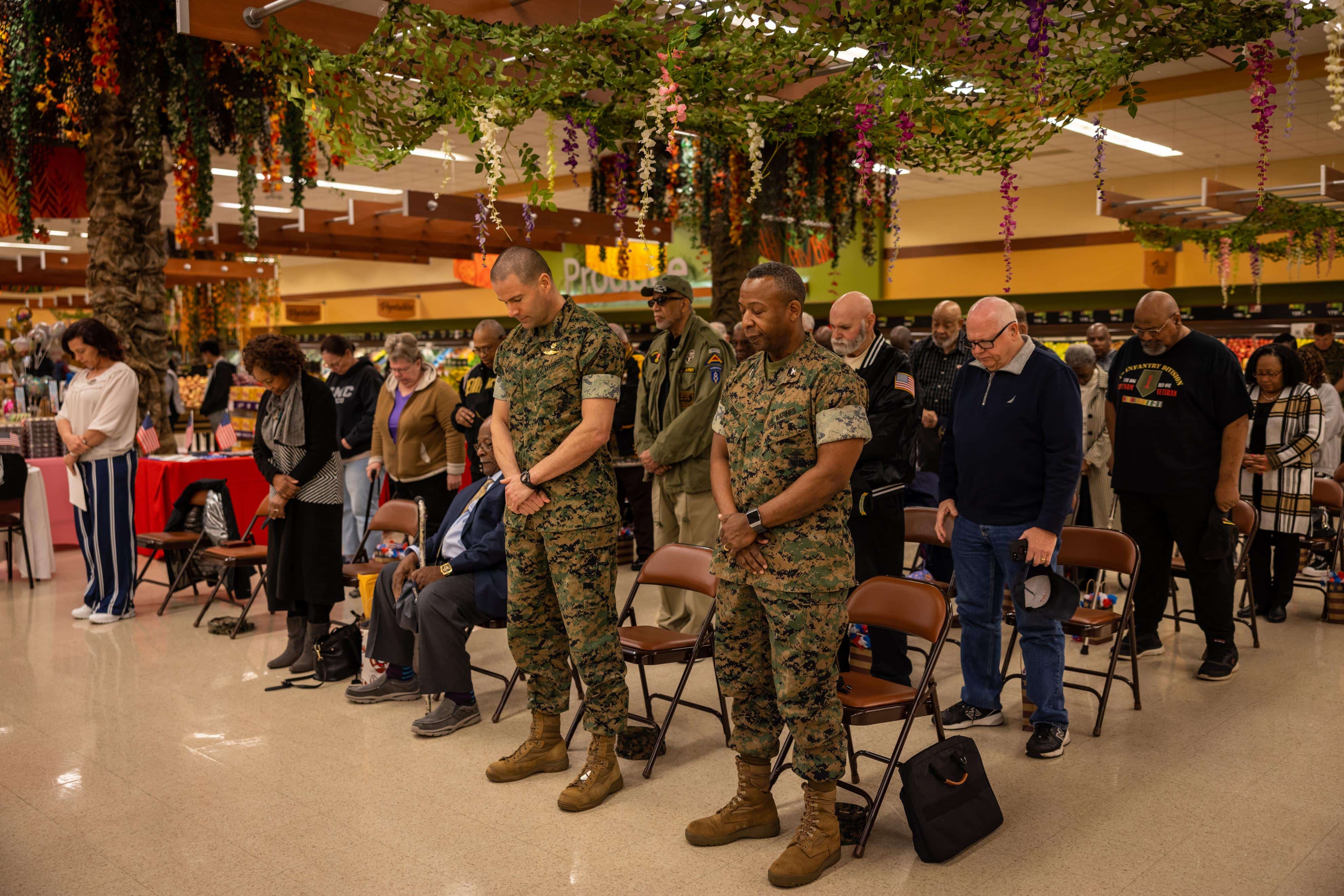U.S. Marine Corps Sgt. Maj. Collin D. Barry, sergeant major, Marine Corps Base Quantico, left, and U.S. Marine Corps Col. Michael L. Brooks, base commander, MCB Quantico, right, bow their heads in prayer with Vietnam War veterans during the National Vietnam War Veterans Day commemoration ceremony at MCB Quantico, Virginia, March 29, 2023. In 2017, President Donald Trump declared National Vietnam War Veterans Day because on this day in 1973, U.S. combat troops departed the Republic of Vietnam. (U.S. Marine Corps photo by Lance Cpl. Joaquin Dela Torre)