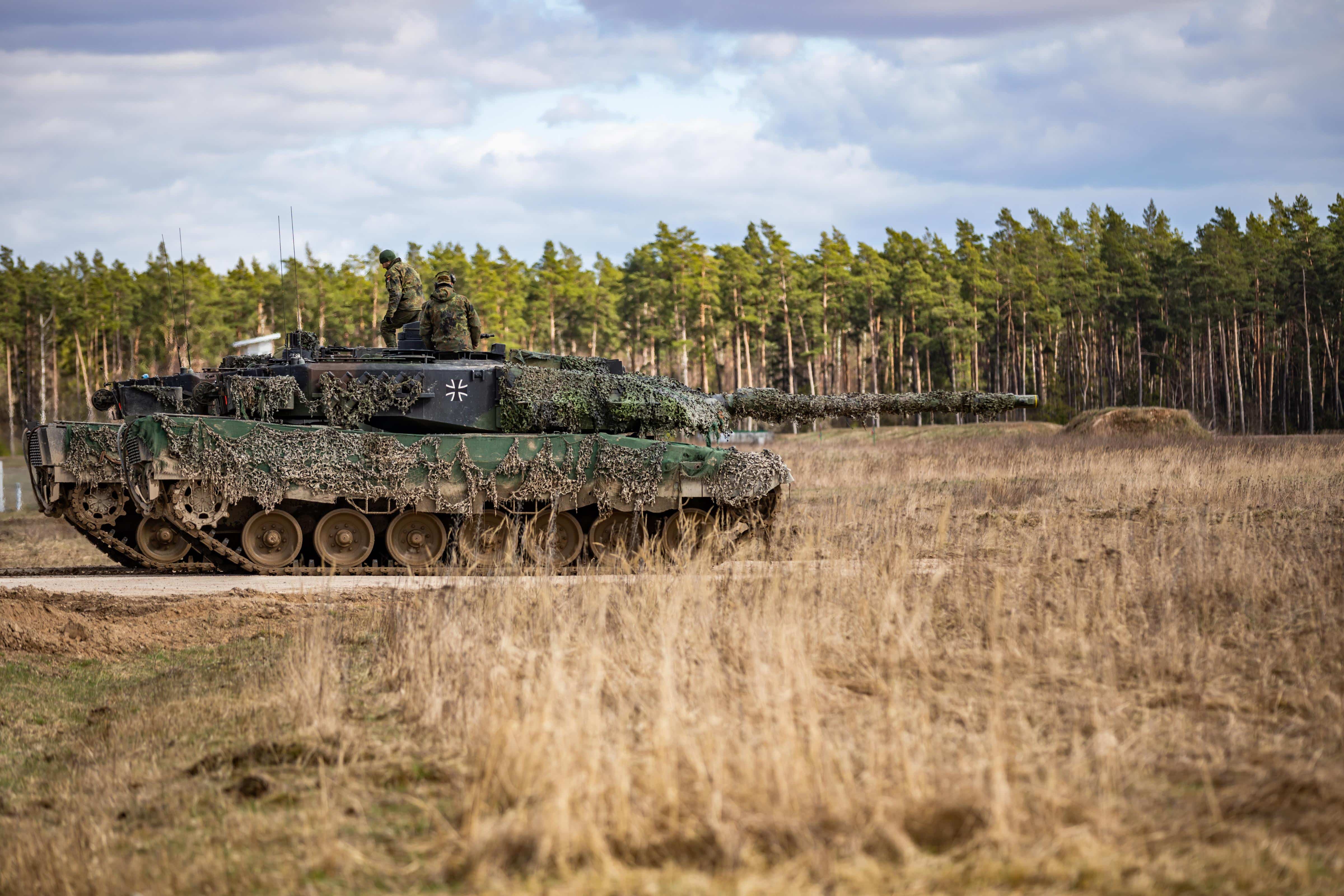 German soldiers assigned to the 93 Armored Demonstration Battalion, 9th Panzerlehr Brigade, 1st Panzer Division, maneuver a Leopard 2A6 tank onto the range during a combined arms live fire exercise in Bemowo Piskie, Poland, April 3, 2023. The 4th Infantry Division’s mission in Europe is to engage in multinational training and exercises across the continent, working alongside NATO allies and regional security partners to provide combat-credible forces to V Corps, America’s forward deployed corps in Europe. (U.S. Army National Guard photo by Sgt. John Schoebel)