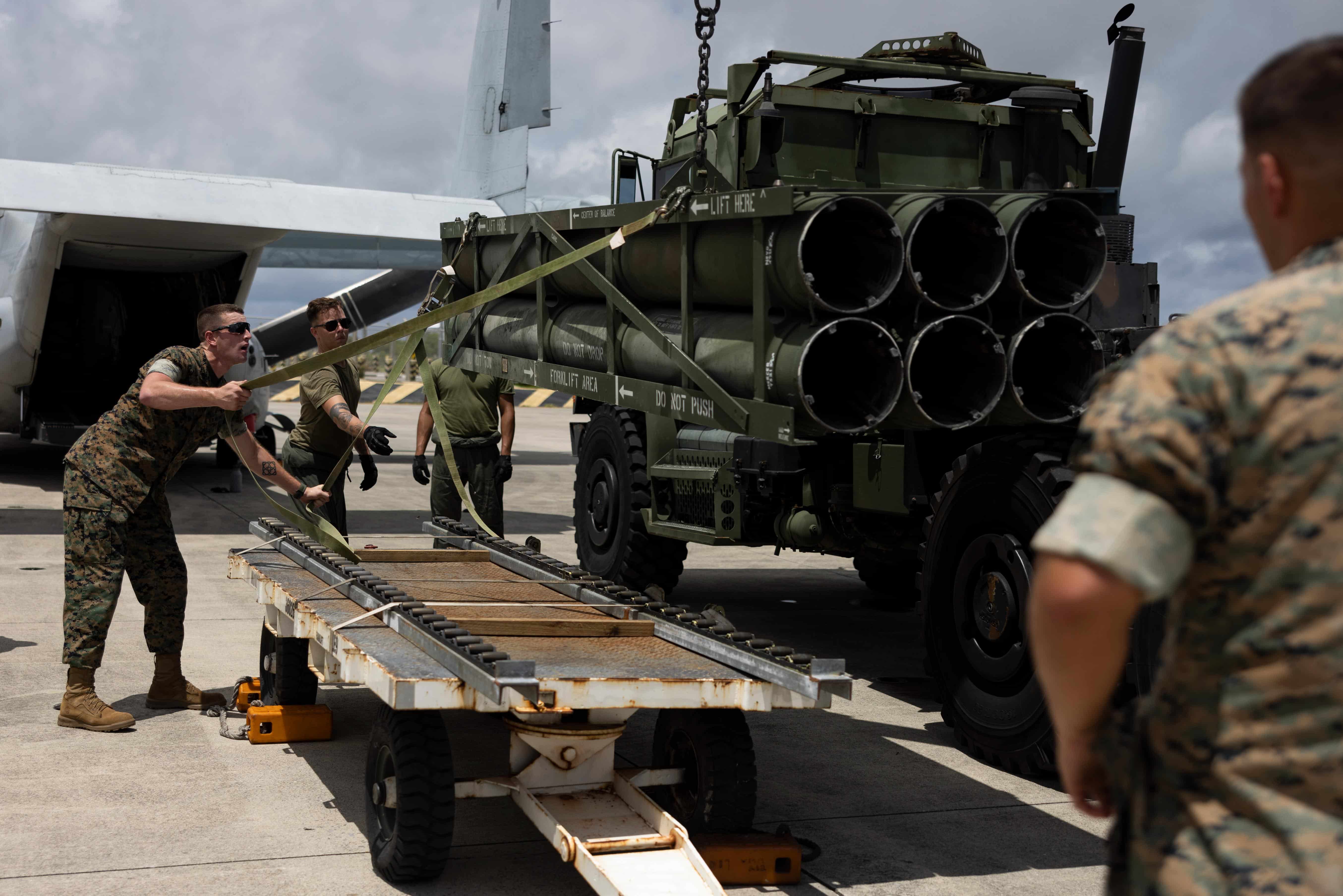 U.S. Marines with Marine Medium Tiltrotor Squadron (VMM) 265, 1st Marine Aircraft Wing, and 3rd Battalion, 12th Marines, test a prototype loading system, which allows the High Mobility Artillery Rocket System (HIMARS) launch pod to be loaded into the back of an MV-22B Osprey