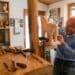 Sebastian Demmel, a German woodworker, works on a Trojan horse carving for a customer at his workshop in Bad Tölz, Germany, Dec. 1, 2023. Demmel has earned the titles of Honorary Green Beret from the United States Special Operations Command, and Honorary Original from 10th Special Forces Group (Airborne), as an appreciation for over 50 years of service to the Special Operations community. (U.S. Army photo by Sgt. Alejandro Lucero)