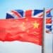 Flags of China and Great Britain against the background of the blue sky
