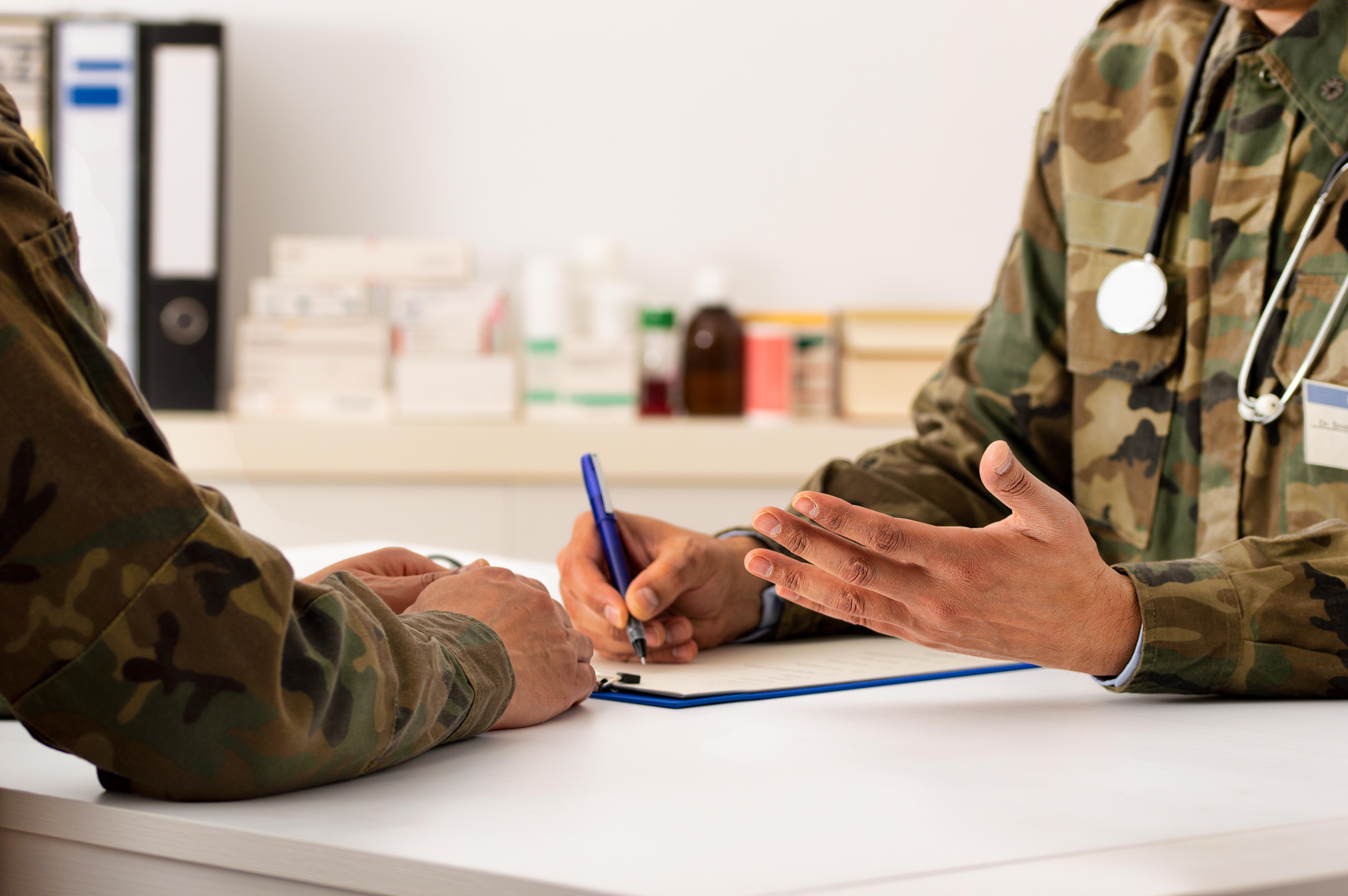 Cropped shot of a army doctor a giving his patient advice during a consult