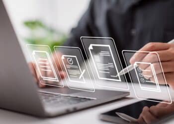 Paperless workplace idea, e-signing, electronic signature, document management. A businessman signs an electronic document on a digital document on a virtual notebook screen using a stylus pen.