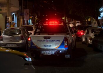 Puerto Vallarta Mexico Nov 27 2021: Police truck with sign Municipal Police and siren lights on drive through the Mexican city night.