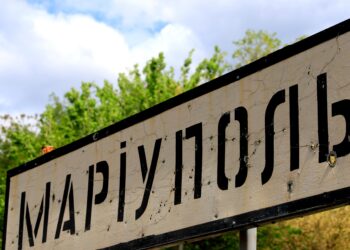 Road sign of Ukrainian city Mariupol, Donetsk region, punched by bullets during Russia Ukrainian war in Donbass, Ukraine